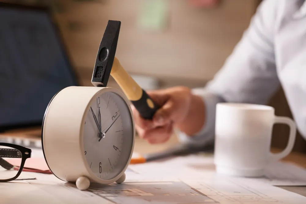 resized_close-up-businesswoman-hitting-clock-her-desk-while-working-office