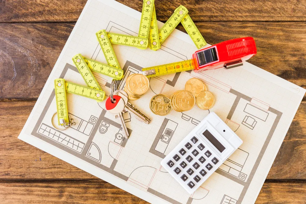 resized_elevated-view-measure-tape-stacked-coins-key-calculator-blueprint