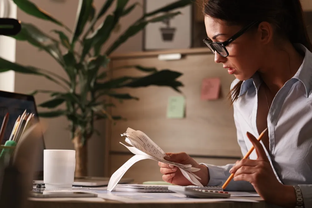 resized_female-accountant-calculating-tax-bills-while-working-finances-office